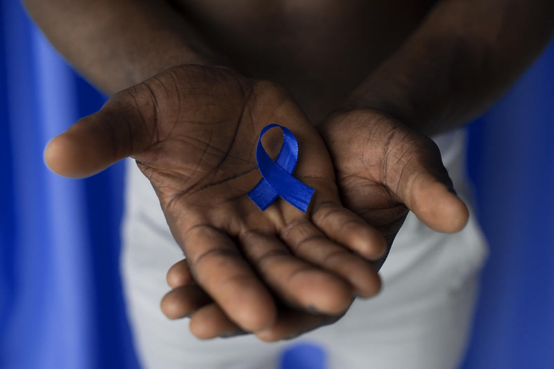 mans hands with blue ribbon