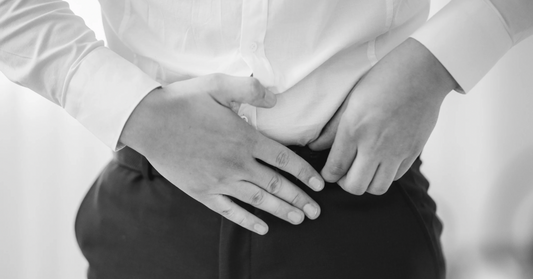 man adjusting pants near prostate area